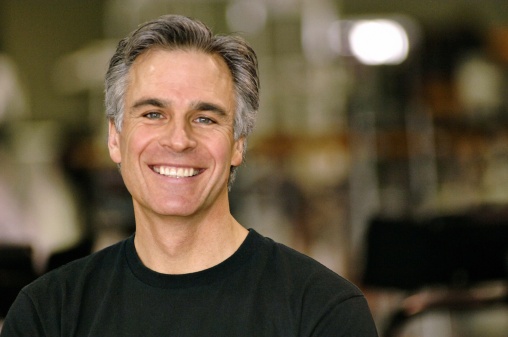 mature man smiling with greying hair